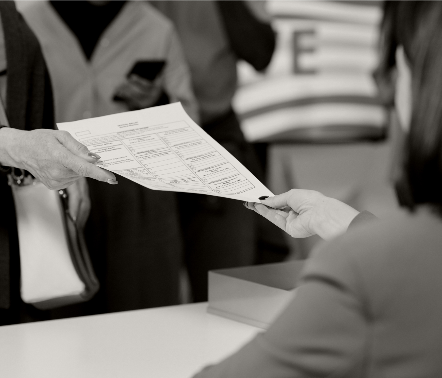 A person hands in an election ballot.